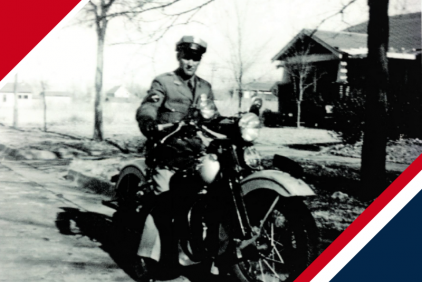 Black and white photo of motorcycle and officer